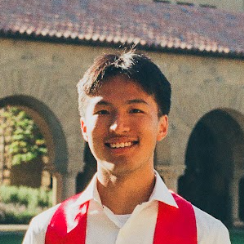 A picture of an Asian-American young man in front of the sandstone arches of Stanford University's main quad.